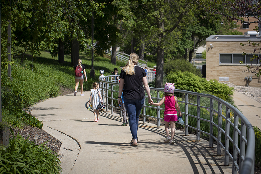 Photo of staff walking with kids.